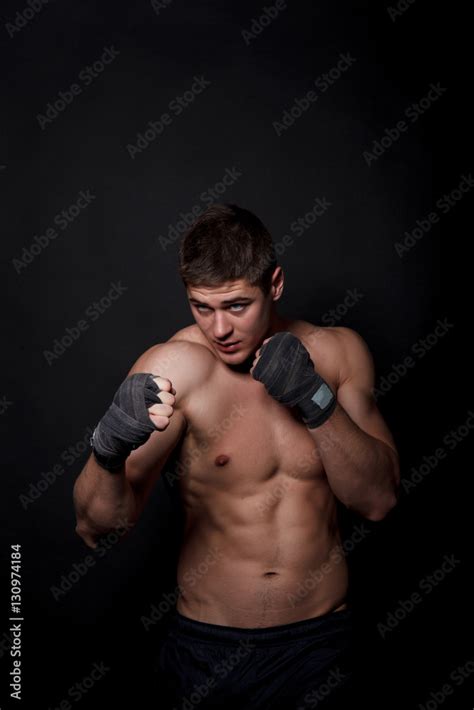 Muscular Athletic Man Boxing On A Black Background A Man With A Naked