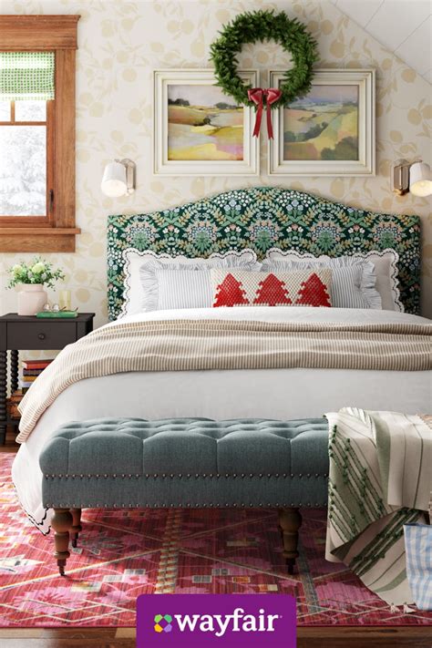 a bedroom with a large bed and green headboard on top of a pink rug