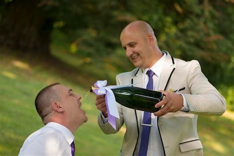 Premium Photo Groom Pouring Alcohol In Friend Mouth During Wedding Celebration