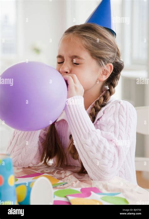 Girl blowing up balloon party hi-res stock photography and images - Alamy