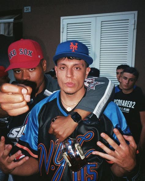 Two Men In Baseball Caps Pointing At The Camera