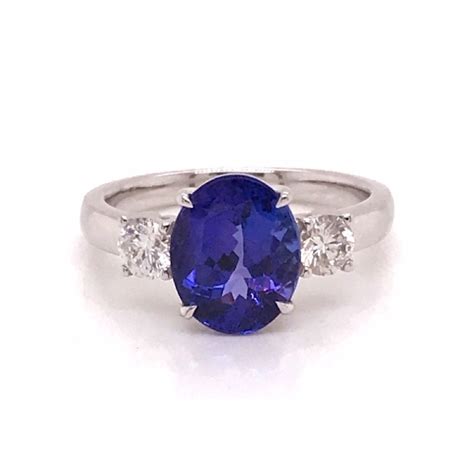 Oval Tanzanite And Brilliant Cut Diamond Three Stone Engagement Ring