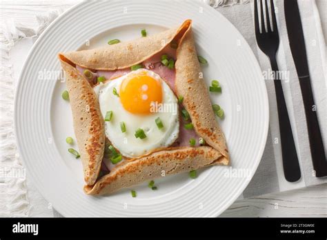 Breton crepe, Savory Buckwheat Galettes Bretonnes with fried egg, cheese, ham closeup on the ...