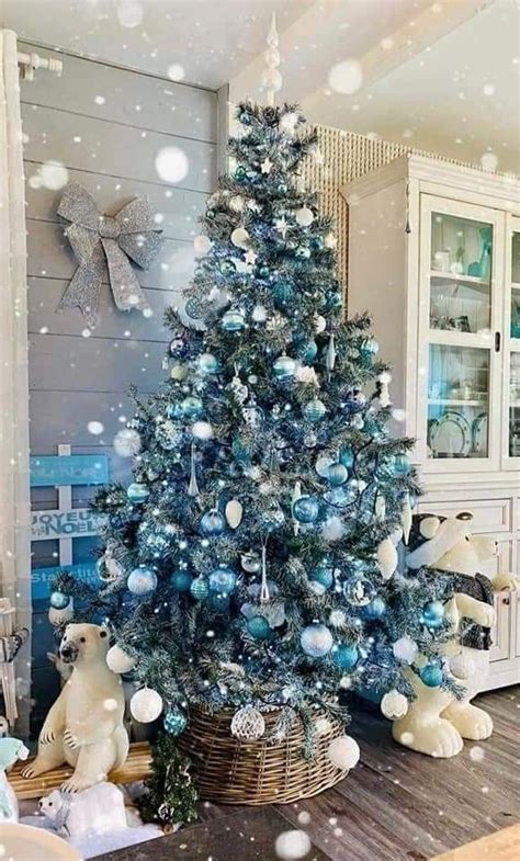 A Blue Christmas Tree With White And Silver Ornaments