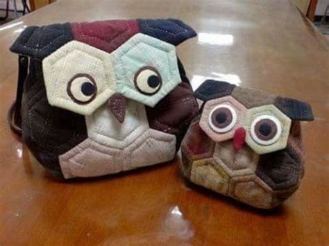 Two Stuffed Owls Sitting On Top Of A Wooden Table