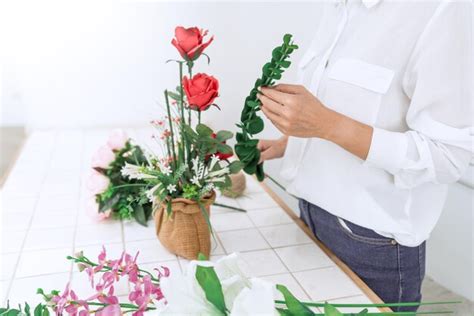 Premium Photo Midsection Of Florist Making Bouquet Against Wall