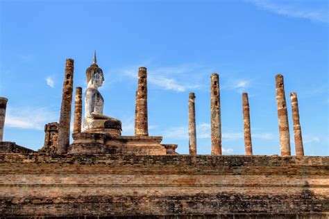 Premium Photo | Ancient Buddha statue sitting posture among the ruins ...