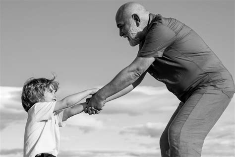 Premium Photo Grandfather Playing With His Grandson