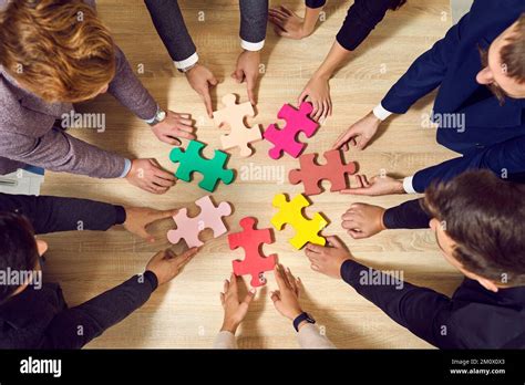 Colored Puzzle Pieces That Business People Connect Together During Team