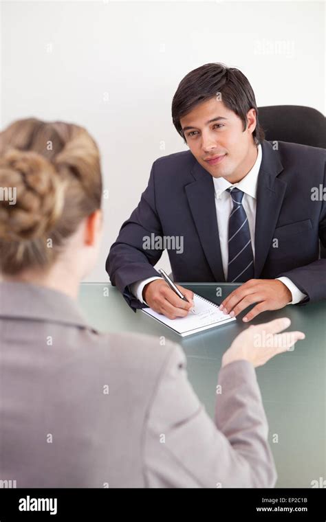 Portrait Of A Smiling Manager Interviewing A Female Applicant Stock