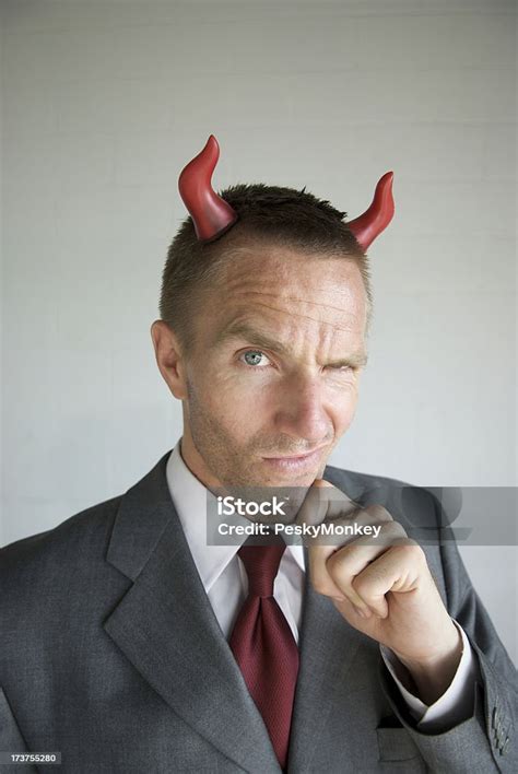 Devilish Businessman With Devil Horns Smirking Stock Photo Download