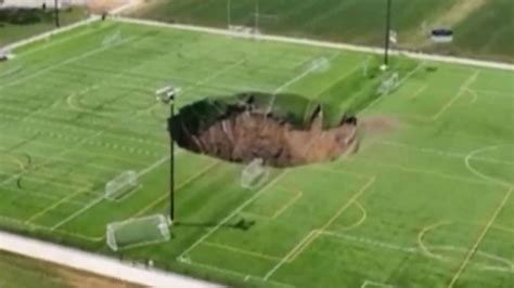 Watch Horror Moment Football Pitch Collapses As 100 FOOT Sinkhole