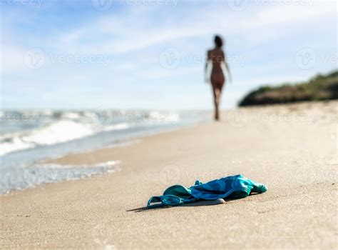 Swimsuit In The Sand On The Beach And Naked Female Figure