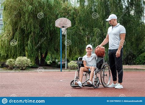 Dad Plays With His Disabled Son On The Sports Ground Concept