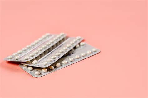 A Blister Of Birth Control Pills On A Pink Background The Concept Of