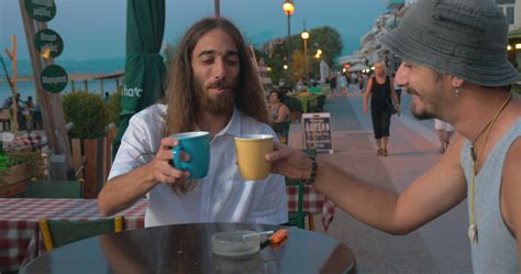 Two friends talking in cafe on waterfront 29760705 Stock Video at Vecteezy