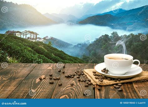 Morning Cup of Coffee and Coffee Beans with Mountain Background at Sunrise. Beauty Mountain ...