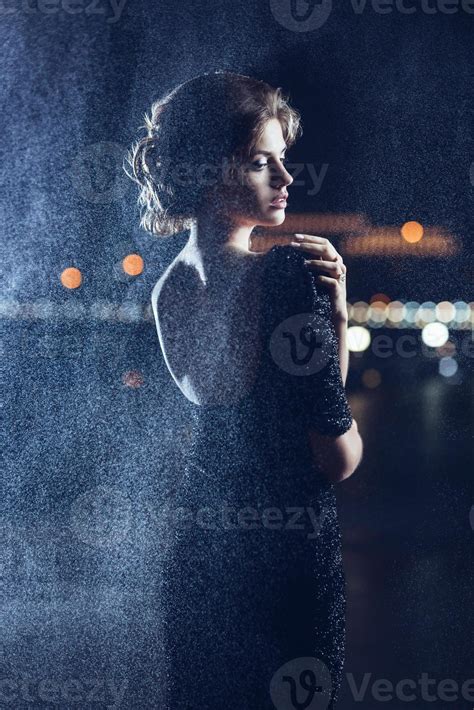 Woman posing in the rain. 1261469 Stock Photo at Vecteezy