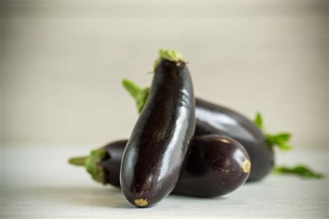 Premium Photo Ripe Purple Eggplant On A Wooden Background