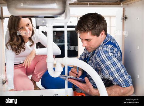 Female Plumber Under Sink Hi Res Stock Photography And Images Alamy