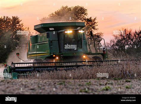 A John Deere Combine Picking Soybeans At Dusk Stock Photo Alamy