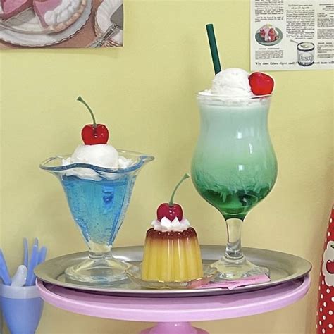 Three Desserts Are Sitting On A Small Table