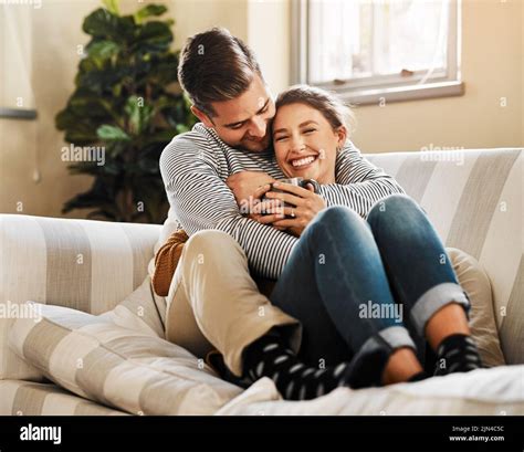 Couple cuddle sofa hi-res stock photography and images - Alamy