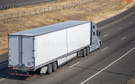 Gray Powerful Industrial Big Rig Semi Truck Transporting Cargo In Dry