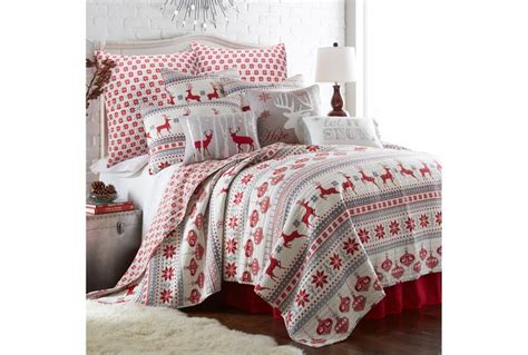 A Bed Covered In Red And White Christmas Themed Bedspreads With