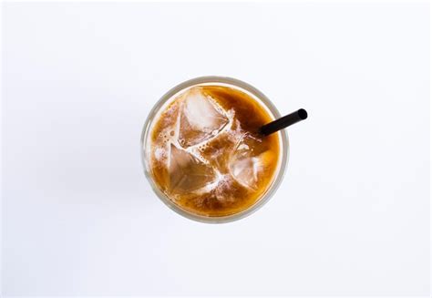 Premium Photo Iced Coffee With Milk In The Drinking Glass On The