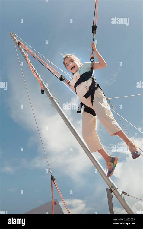 Jumping Rubber Band In An Amusement Park Girl Jumping On A Trampoline