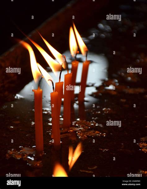 Candles burning in a church Stock Photo - Alamy