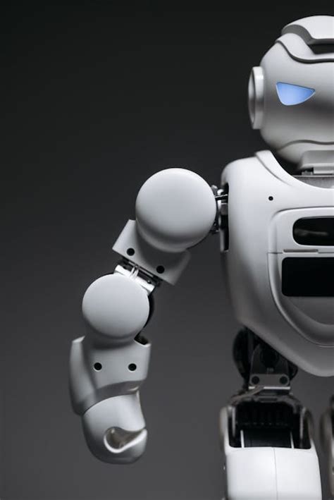 White Robot Toy In Close Up Photography · Free Stock Photo