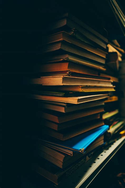 Download Pile Of Books In The Dark Wallpaper | Wallpapers.com