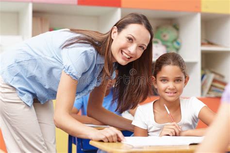 Her Favourite Student Portrait Of An Attractive Young Teacher Helping