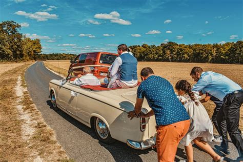 People Pushing a Vintage Car · Free Stock Photo