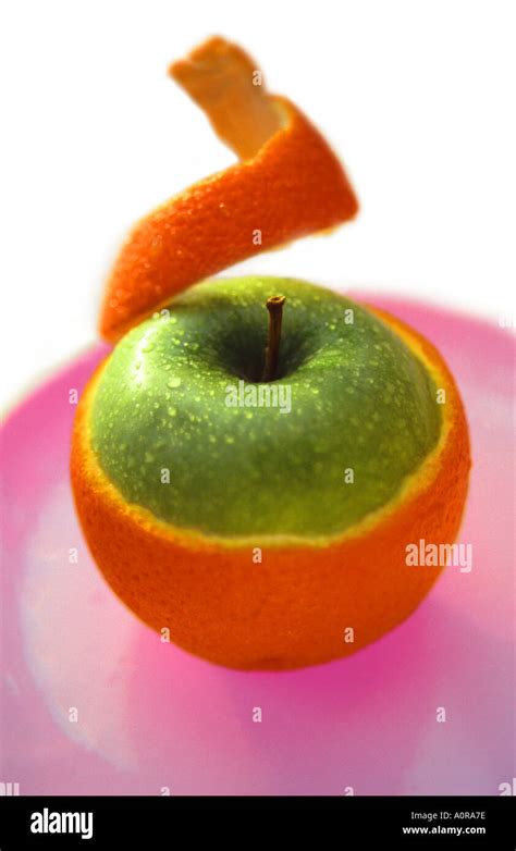 Half Peeled Orange Revealing Apple Inside Stock Photo Alamy