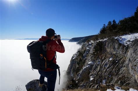 Man Photographing Alone On Cliff Edge Mountains Above Clouds Travel