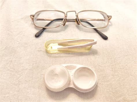 A Set For Contact Lenses With A Container Forceps Glasses The