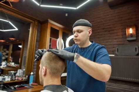 Working Process Professional Barber Serving Client Making Trendy Haircut For Young Caucasian