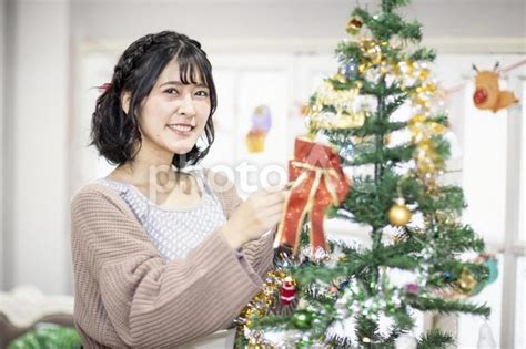 クリスマスツリーの飾りつけをする女性 No 22799838｜写真素材なら「写真ac」無料（フリー）ダウンロードok