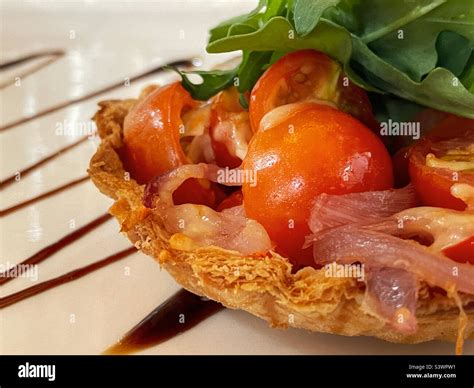 Tomato And Bacon Tart With Rocket Lettuce Stock Photo Alamy