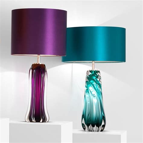 Three Different Colored Lamps Sitting On Top Of Each Other