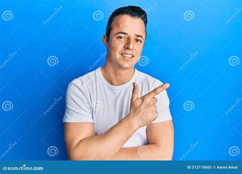 Handsome Young Man Wearing Casual White T Shirt Smiling Cheerful Pointing With Hand And Finger