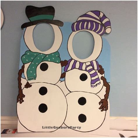 Two Snowmen With Hats And Scarves On Their Heads Are Standing Next To