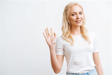 유토이미지 happy beautiful woman waving hand while isolated on white