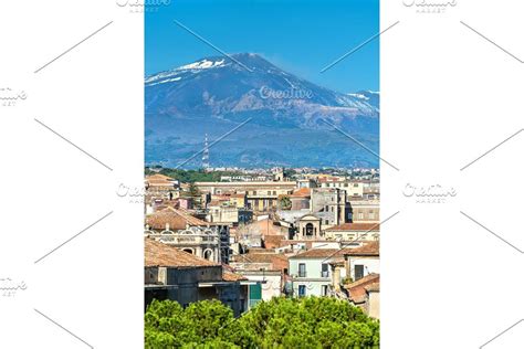 View of the historic centre of Catania with Etna Volcano in the ...