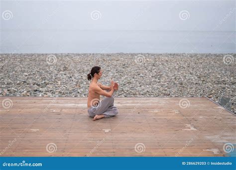 Caucasian Man With Naked Torso Practicing Wushu On The Seashore Stock