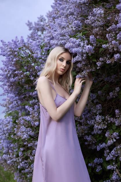 Premium Photo Portrait Of Woman In Lilac Bushes In Purple Dress Face