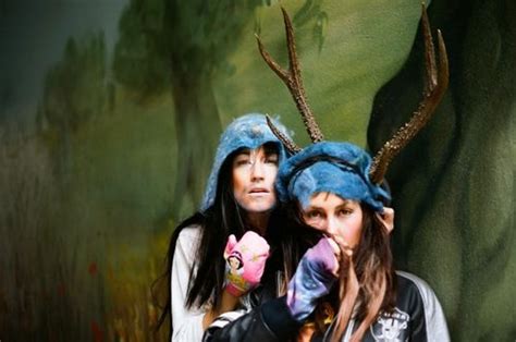 Two Women Dressed In Costumes With Horns On Their Heads